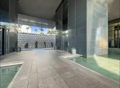 a building with a pool in the middle of a courtyard at Index Tower DIFC with Burj Khalifa View Chic 1 BR in Dubai