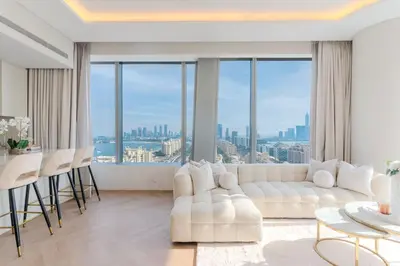 a living room with a white couch and a table at Daniels 1BR with Sea View at The Palm Tower in Dubai