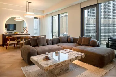 a living room with a couch and a table at Seraya Residences at Address Opera Dubai in Dubai