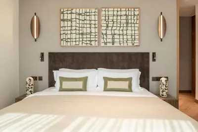 a bedroom with a large white bed with two pillows at Seraya Residences at Address Opera Dubai in Dubai