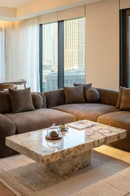 a living room with a couch and a coffee table at Seraya Residences at Address Opera Dubai in Dubai