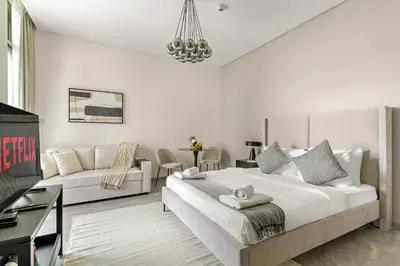 a bedroom with a large bed and a couch at VayK - Elegant Canal View studio in Business Bay in Dubai