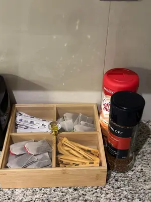 a wooden box with matches and a cup of coffee at Livincci - Luxury Studio Burj Khalifa View - 12 in Dubai