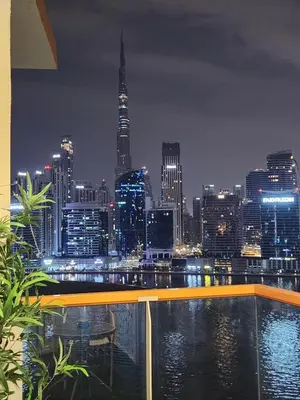 a view of a city skyline at night at Livincci - Luxury Studio Burj Khalifa View - 12 in Dubai