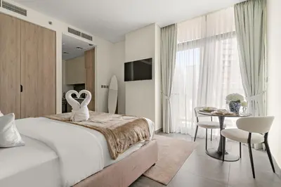 a bedroom with a bed and a table and chairs at Elegant Studio in Peninsula One, Business Bay in Dubai