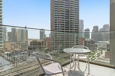 a table and chairs on a balcony with a view of a city at Elegant Studio in Peninsula One, Business Bay in Dubai