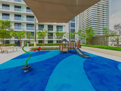 a playground with a slide and a swing at Beach access 2BR with Balcony & Sea View in Dubai