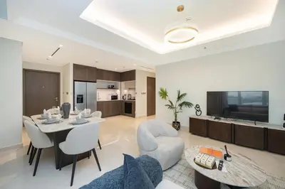 a living room with a table and chairs at Beach access 2BR with Balcony & Sea View in Dubai