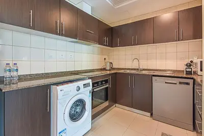 a kitchen with a washing machine and a dishwasher at Modern 1-Bedroom Apartment in Bay Central Tower 1 in Dubai