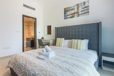 a bedroom with a bed with a towel on it at Modern 1-Bedroom Apartment in Bay Central Tower 1 in Dubai