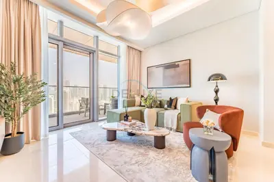 a living room with a couch and a table at Breathtaking Burj Khalifa Views from a High-Floor 3BR with an Assistant Room, Just Minutes from Dubai Mall and Downtown Attractions, Imperial Avenue, Downtown Dubai by Deluxe Holiday Homes in Dubai