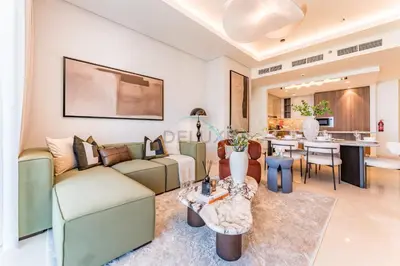 a living room with a couch and a table at Breathtaking Burj Khalifa Views from a High-Floor 3BR with an Assistant Room, Just Minutes from Dubai Mall and Downtown Attractions, Imperial Avenue, Downtown Dubai by Deluxe Holiday Homes in Dubai