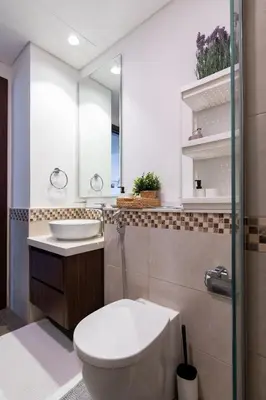 a bathroom with a toilet and a sink and a mirror at 1Bedroom Canal View near Dubai Mall-Business Bay in Dubai