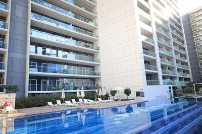 a swimming pool in front of a building at 1Bedroom Canal View near Dubai Mall-Business Bay in Dubai