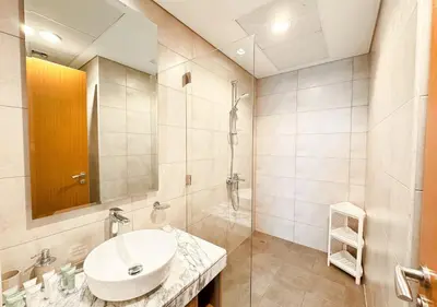 a bathroom with a sink and a shower at Dream Shoma- Experience Luxury Living 2BR APT in Dubai