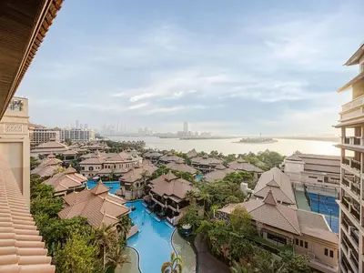 arial view of a resort with a river and buildings at Livin' Holidays - 1 BR - Anantara Lagoon Stay in Dubai