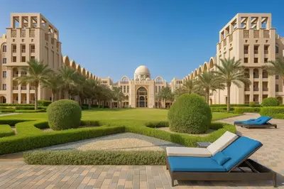 a view of a building with palm trees and a blue chair at Sunset Beach Escape at Palm Jumeirah 2BR 241 by The Rosewood Vacation Homes Rental LLC in Dubai