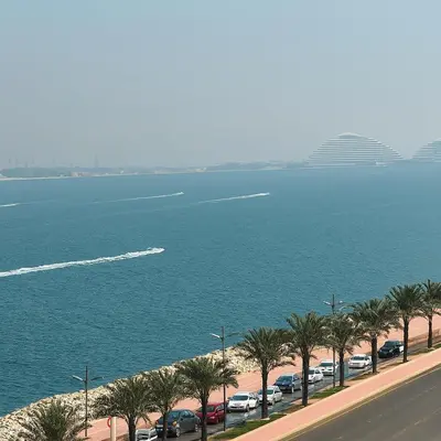 a view of the ocean and a parking lot with palm trees at Sunset Beach Escape at Palm Jumeirah 2BR 241 by The Rosewood Vacation Homes Rental LLC in Dubai