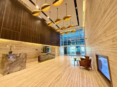 a lobby with a chair and a chandelier at Duja Tower 4114 in Dubai