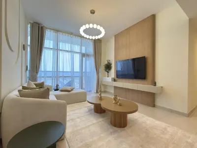 a living room with a couch and a tv at Duja Tower 4114 in Dubai