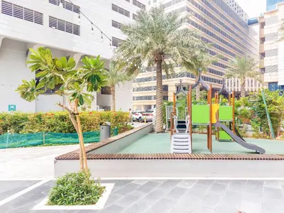 a playground in a city with palm trees at Duja Tower 4114 in Dubai