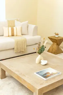 a living room with a white couch and a coffee table at PVH - Sea View 3BR and Maids Room - Princess Tower in Dubai