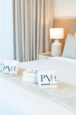 a hotel room with two towels on a bed at PVH - Stunning 2BR - Creek Vistas Grande in Dubai