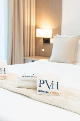 a hotel room with two beds and two towels at PVH - Stunning 2BR - Creek Vistas Grande in Dubai