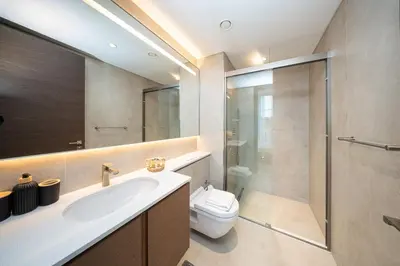 a bathroom with a toilet and a sink and a shower at PVH - Stunning 2BR - Creek Vistas Grande in Dubai