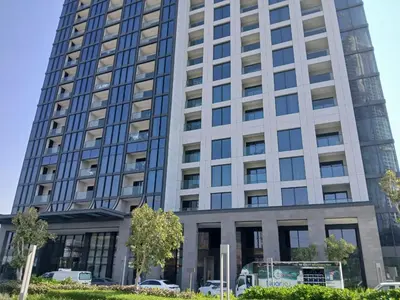 a tall building with cars parked in front of it at PVH - Stunning 2BR - Creek Vistas Grande in Dubai
