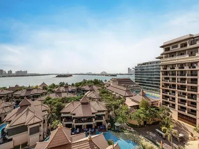 an aerial view of a resort with a body of water at Livin' Holidays - 2 BR - Anantara Palm Stay in Dubai