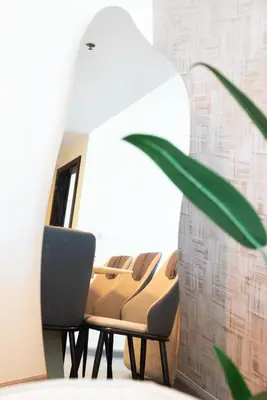 a row of chairs in a room with a mirror at Modern 1BR I Canal View I Business Bay Dubai in Dubai