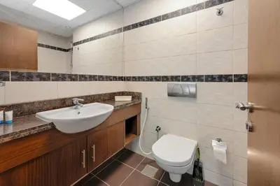 a bathroom with a sink and a toilet at Modern 1BR I Canal View I Business Bay Dubai in Dubai