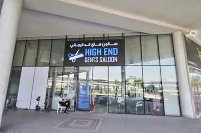 a man sitting in a chair in front of a high endents salon at Modern 1BR I Canal View I Business Bay Dubai in Dubai