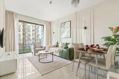 a living room with a couch and a table at FIRST CLASS 1BR Burj Khalifa View , Near Metro in Dubai