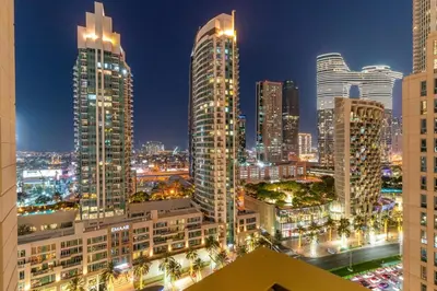 a city skyline at night with tall buildings at FIRST CLASS 1BR Burj Khalifa View , Near Metro in Dubai