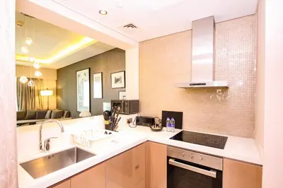 a kitchen with a sink and a counter at Modern 1BHK With World Class Amenities at Paramount Tower in Dubai