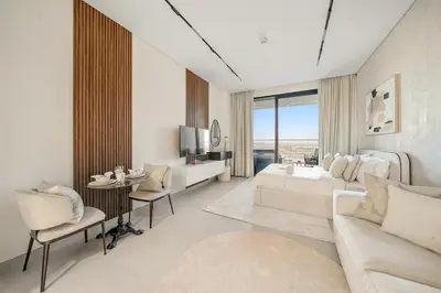 a living room with a bed and a couch and a table at FIRST CLASS Studio Canal and Pool View in Dubai
