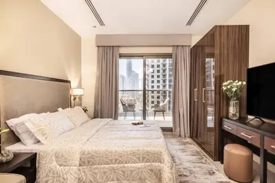 a hotel room with a bed and a balcony at Studio in downtown of Dubai in Dubai