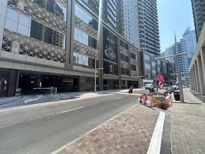 an empty street in a city with tall buildings at Studio in downtown of Dubai in Dubai