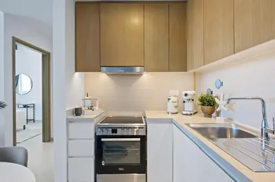 a kitchen with a sink and a stove top oven at Luxury Seaview Apartment Near Bluewaters & JBR in Dubai