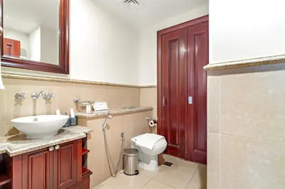 a bathroom with a white toilet and a sink at FIRST CLASS 1BR Cozy Old Town Escape in Dubai