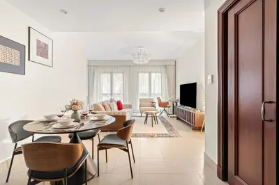 a dining room and living room with a table and chairs at FIRST CLASS 1BR Cozy Old Town Escape in Dubai
