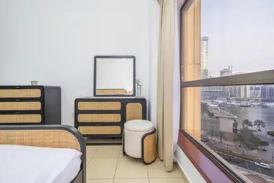 a room with a window with a bed and a mirror at Rimal 1 JBR Beach Access 3 BR in Dubai