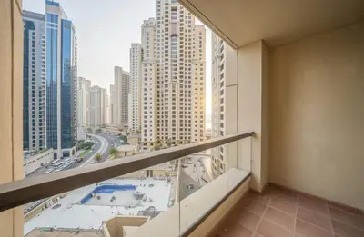 an apartment balcony with a view of a city at Rimal 1 JBR Beach Access 3 BR in Dubai
