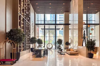 a lobby with a table and chairs and windows at PVH - Vibrant 1BR near Dubai Opera - BLVD Heights in Dubai