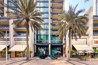 a group of palm trees in front of a building at PVH - Vibrant 1BR near Dubai Opera - BLVD Heights in Dubai
