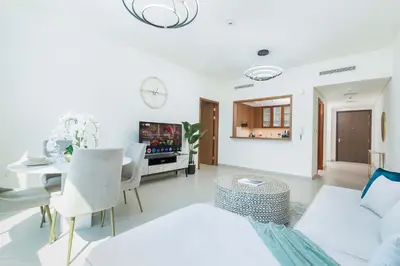 a living room with a white couch and a table at PVH - Vibrant 1BR near Dubai Opera - BLVD Heights in Dubai