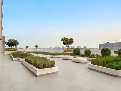 a courtyard with some plants and trees in a building at FIRST CLASS 1BR Cozy Luxe Escape in Dubai