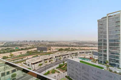an aerial view of a city with a tall building at FIRST CLASS 1BR Cozy Luxe Escape in Dubai